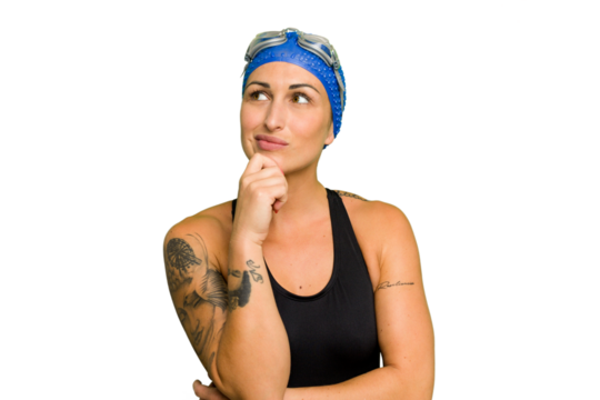 Young caucasian swimmer woman isolated on green chroma background looking sideways with doubtful and skeptical expression.