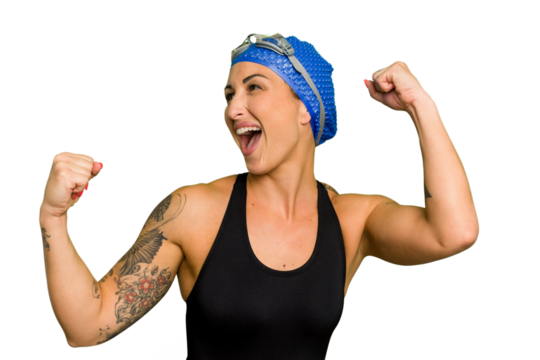 Young caucasian swimmer woman isolated on green chroma background raising fist after a victory, winner concept.