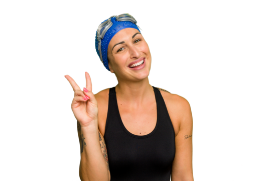 Young caucasian swimmer woman isolated on green chroma background joyful and carefree showing a peace symbol with fingers.