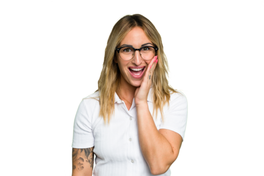 Young caucasian woman isolated on green chroma background shouts loud, keeps eyes opened and hands tense.