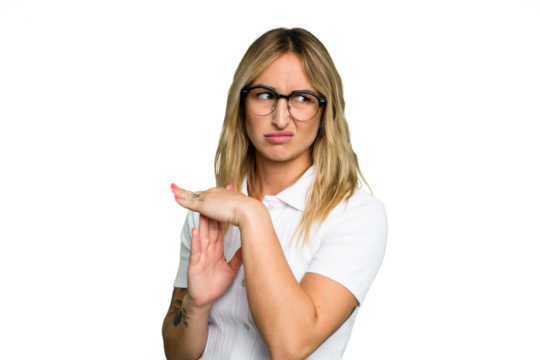 Young caucasian woman isolated on green chroma background showing a timeout gesture.