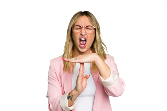 Young caucasian woman isolated on green chroma background showing a timeout gesture.