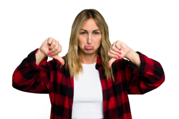 Young caucasian woman isolated on green chroma background showing a dislike gesture, thumbs down. Disagreement concept.
