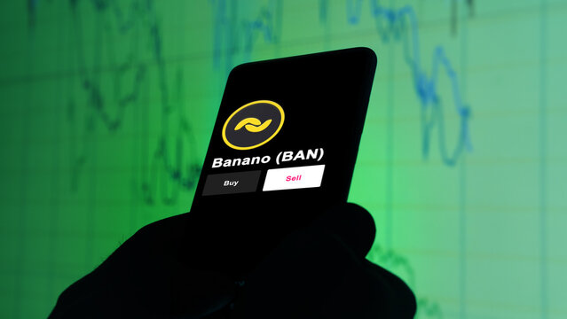 September 13th 2022, London UK. An investor's analyzing the Banano (BAN) coin on screen. A phone shows the crypto's prices serieDark_33.jpg to invest