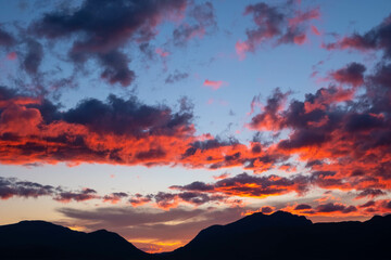 A beautiful sunset over mountains on the horizan