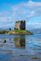 Castle Stalker on loch linnhe, coastline of argyll. A four-storey tower house/keep on a loch on a tidal islet. A small castle on a tiny island in Sotland. 