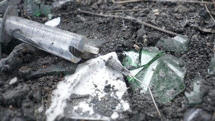 Used syringes, discarded,  Syringes lie in an abandoned house, at a construction site, in ruins, in the garbage, drug addicts left the drug