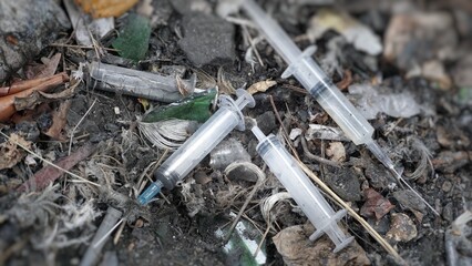 Syringes lie in an abandoned house, at a construction site, in ruins, in the garbage, drug addicts left the drug