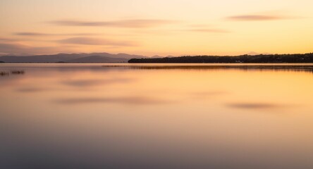 View of a beige sunset sky reflecting on the Lake Champlain