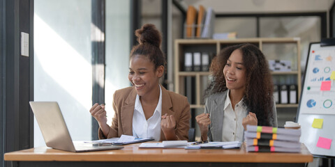 Two young Asian business woman talk, consult, discuss working with new startup project idea...