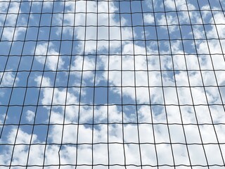 Sky with clouds behind bars.