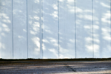 Fototapeta na wymiar White wall with shadow patterns