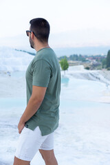 Unrecognizable young man in the Cotton Castles of Pamukkale