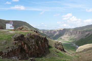 house on hill in mountain valley. Caucasus