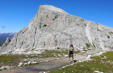 woman with backpack on her shoulders during the walk on the path