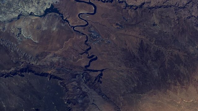 Flying over rock and sand Glen Canyon and lake Powell in United States, sunrise animation aerial satellite view from space based on image by Nasa