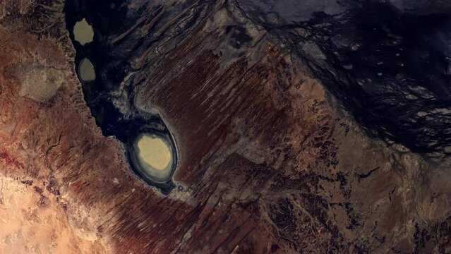 Flying over rock and sand desert Queensland Australia, sunrise animation aerial satellite view from space based on image by Nasa