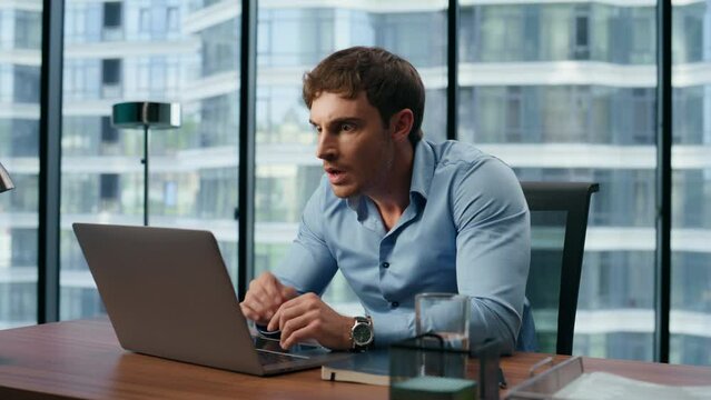 Shocked man reading bad news office. Big eyes businessman looking laptop screen