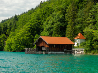 Fototapeta na wymiar Wooden dock houses on the lake with typical wooden pier,