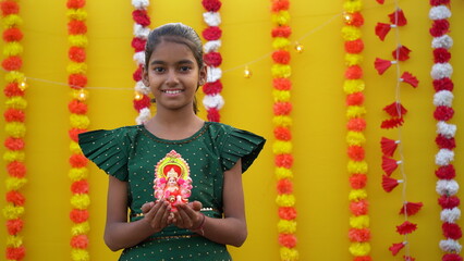 Beautiful Girl Holding Ganesha Statue on Diwali Festival