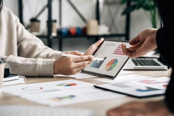 Business professionals. Young confident business people analyzing data using computer while...