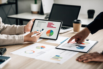 Business professionals. Young confident business people analyzing data using computer while spending time in the office, planning strategy and brainstorming, colleagues thinking concept