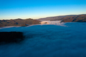 Fototapeta na wymiar Aerial view of morning fog in the valley in dawn