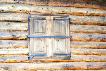 Closed shutters in an old wooden house