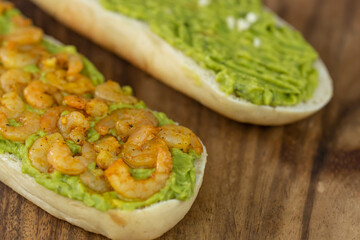 Close up of fresh diet avocado toast with seafood shrimps. Healthy vitamin breakfast.