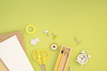 School stationery and stationery lay on green background top view back to school background