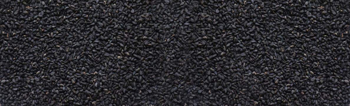There are many black cumin seeds. Selective focus.