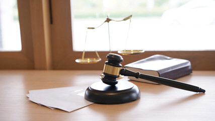 Lawyer or judge's hammer in the court. Auction's hammer and judgement golden scale are on wood...