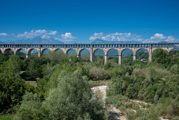 Cuneo, Piedmont, Italy :  The Soleri viaduct, it is a promiscuous road and rail bridge on the Stura di Demonte river, in the background the mountains of the Alps