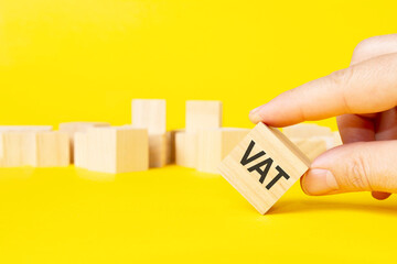 hand holding wood cube block with VAT text. financial, management, economic, business concept