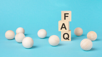 faq - short for exchange to exchange - on a wooden cubes on a blue background