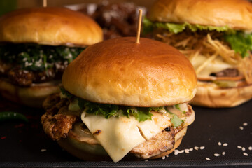 chicken cheese burger isolated on table closeup side view of fastfood