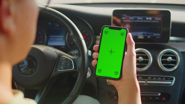 Man Driver Phone Hand with a Green Screen Chroma Key, Male driver checks route on smartphone while sitting at the Car, Modern Application