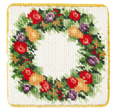 Isolated detail needlepoint coaster of a fruit wreath