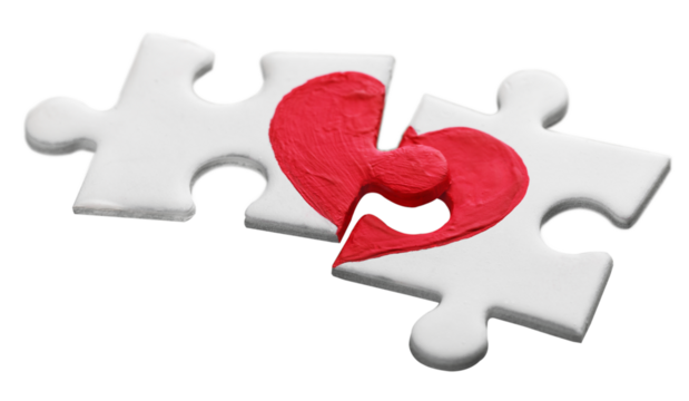 Puzzle pieces with painted red heart isolated on white background