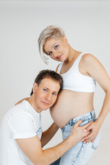Cheerful pregnant european woman hugging her husband
