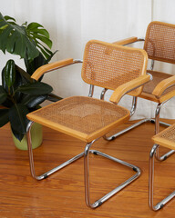 Set of mid-century modern wooden chrome and cane cantilever chairs detail. Interior product...