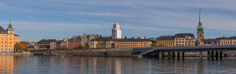 The commuting train bridge Getingmidjan passing the old town islands waterfront an autumn day in Stockholm