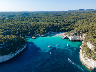 Fototapeta na wymiar aerial view of the Menorcan coastline showing boats enjoying the summer