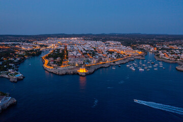 Blue hour aerial view of a city on the coast of Europe. 