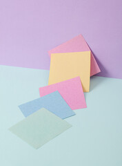 Modern and creative composition with colored memo papers on two tone pastel background. Minimal still life. Business concept