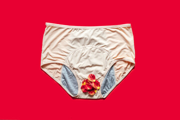 Reusable Period Underwear with rose flower petals on red background. Absorbent and Affordable...