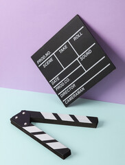 Naklejka premium Creative retro 80s layout with movie clapperboard on pastel background. Conceptual pop. Minimal still life