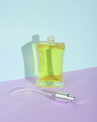 Creative beauty layout with perfume bottle on two tone pastel background. Visual trend.