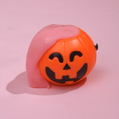 Creative Halloween layout, Bucket with slime on pink background with shadow. Visual trend. Fresh idea. Concept pop. Trick or treat