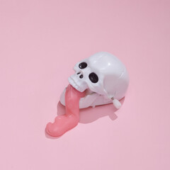 Creative Halloween layout, Skull with slime on pink background with shadow. Visual trend. Fresh idea. Concept pop. Trick or treat